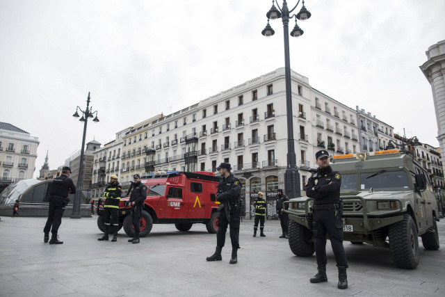 18일(현지시간) 스페인 마드리드에서 군인들이 이동제한령을 어기는 시민을 단속하기 위해 보초를 서고 있다./마드리드=AP연합뉴스