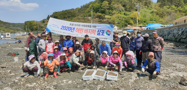 통영 산양 오비도어촌계원들이 23일 마을 앞바다에 토종 바지락 인공종자 200만 마리를 시험살포했다. /사진제공=경남도