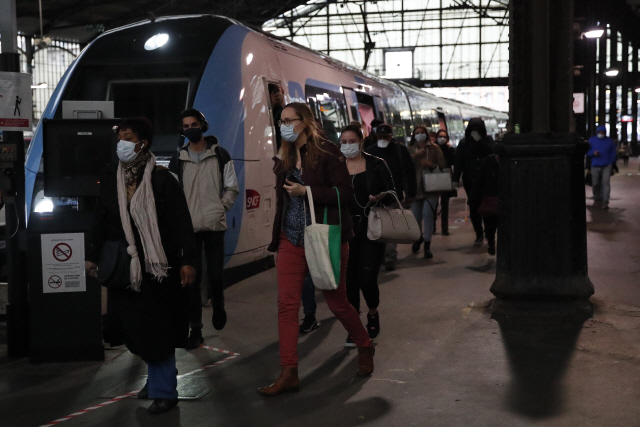 11일(현지시간) 프랑스 파리의 생 라자르 철도역에서 출근하는 시민들이 일제히 마스크를 쓰고 열차를 빠져나오고 있다. 프랑스에서는 이날부터 신종 코로나바이러스 감염증(코로나19) 사태에 따른 이동제한령이 해제됐지만 대중교통 이용시 마스크를 반드시 착용해야 한다. /파리=AP연합뉴스
