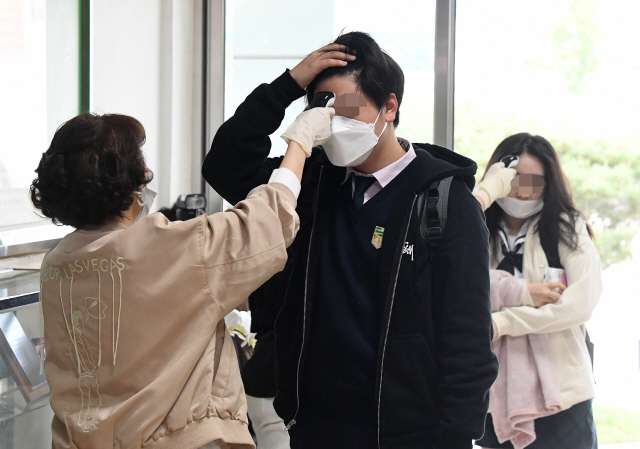 20일 오전 서울의 한 고등학교에서 학생들이 교실로 들어가기 전에 체온측정 및 손 소독을 하고 있다./오승현기자
