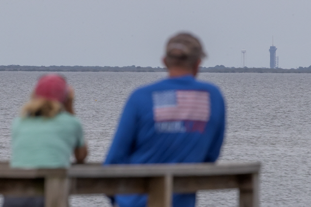 26일(현지시간) 미국 플로리다주에서 시민들이 케네디 우주센터에 설치된 로켓을 바라보고 있다./케이프커내버럴=EPA연합뉴스