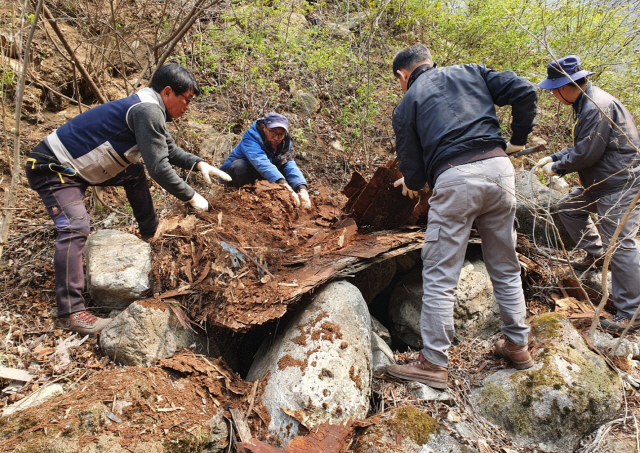경기 가평군 관계자들이 연인산 계곡 인근에 있는 쓰레기를 치우고 있다./사진제공=경기도