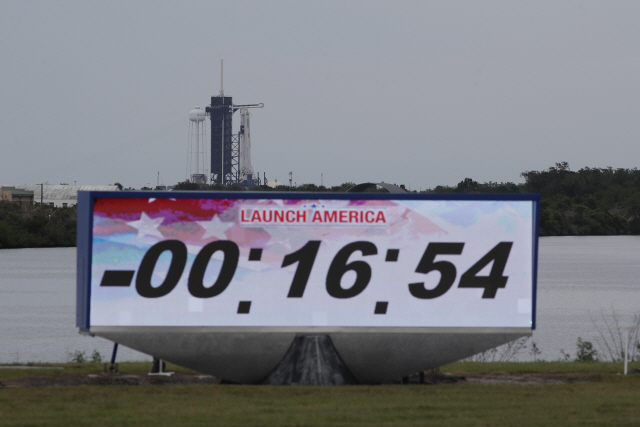 27일(현지시간) 미국 플로리다주 케네디우주센터의 카운트다운 시계가 미국 민간 우주탐사 기업 스페이스X의 첫 유인우주선 발사예정 시각을 16분54초 남겨둔 채 멈춰 섰다. 기상악화로 첫 민간 유인우주선 발사는 30일로 연기됐다. /AP연합뉴스