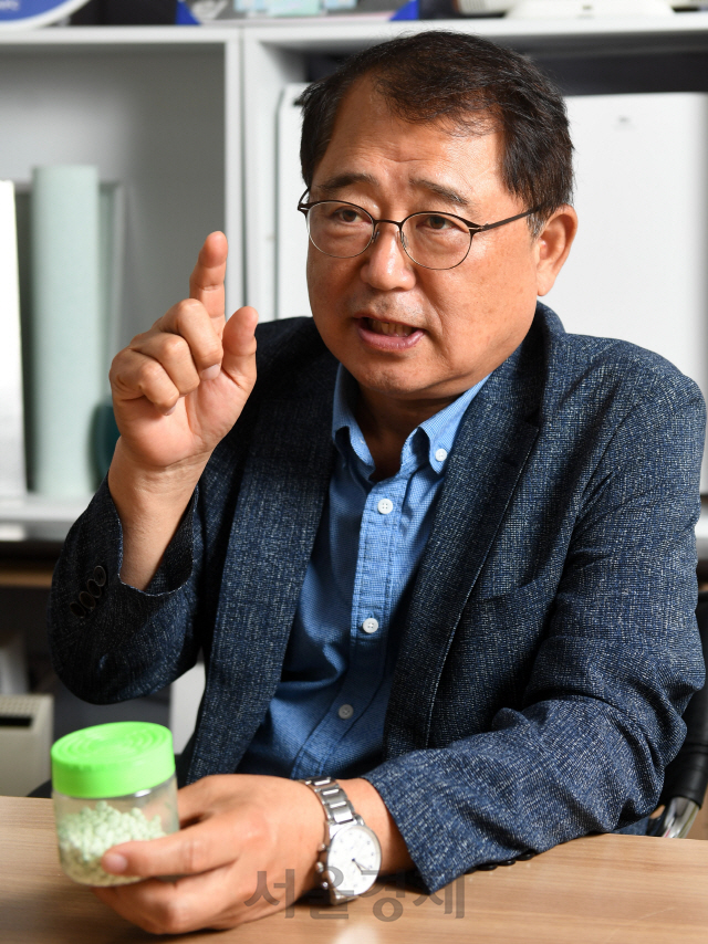 김승진 에이피씨테크 대표가 축광성 광촉매를 구성하는 비드를 들고 특징을 설명하고 있다.