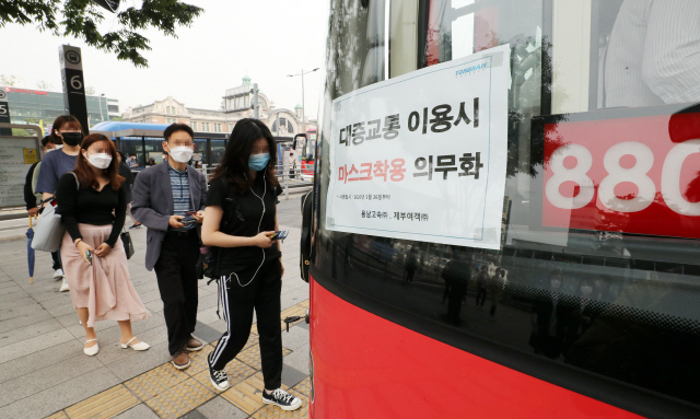 대중교통 이용 시 마스크 착용 의무화가 시행된 지난달 26일 서울역환승센터에서 마스크를 쓴 시민들이 버스에 오르고 있다. /연합뉴스