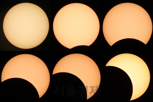 달이 태양을 가리는 부분일식이 진행된 21일 서울 여의도 한강공원에서 바라본 태양이 초승달 모양으로 변하고 있다./권욱기자