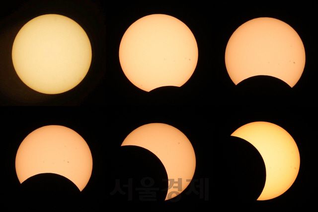 달이 태양을 가리는 부분일식이 진행된 21일 서울 여의도 한강공원에서 바라본 태양이 초승달 모양으로 변하고 있다./권욱기자