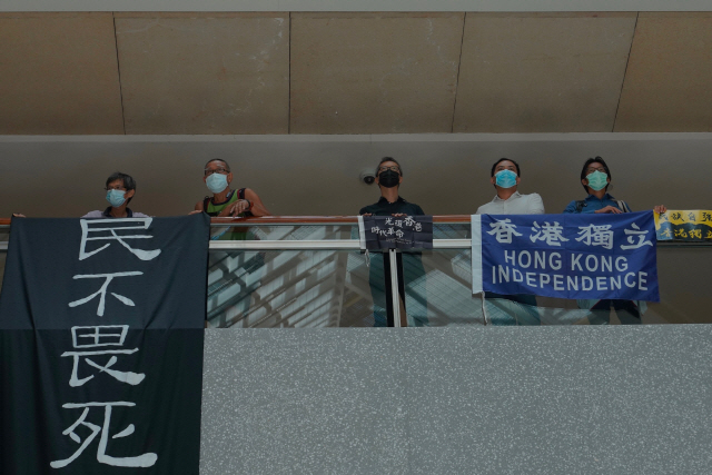 중국 전국인민대표대회 상무위원회가 홍콩 국가보안법을 통과시킨 30일(현지시간) 홍콩 민주화 시위대가 중심가인 센트럴에 있는 한 쇼핑몰에 모여 계단 난간에 ‘민불외사(백성은 죽음을 두려워하지 않는다)’ ‘홍콩 독립’이라고 쓰인 플래카드를 펼쳐 보이고 있다.  /AP연합뉴스