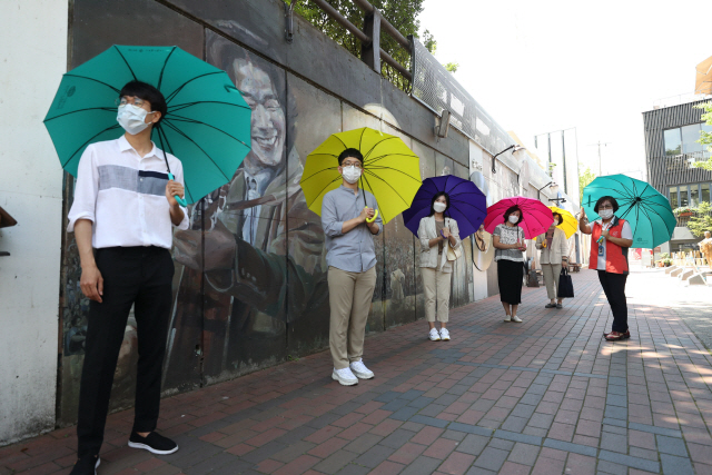 대구 중구 ‘김광석 다시 그리기 길’을 찾은 관광객들이 온열질환을 예방하는 차원에서 양산을 쓰고 골목길을 탐방하고 있다./연합뉴스