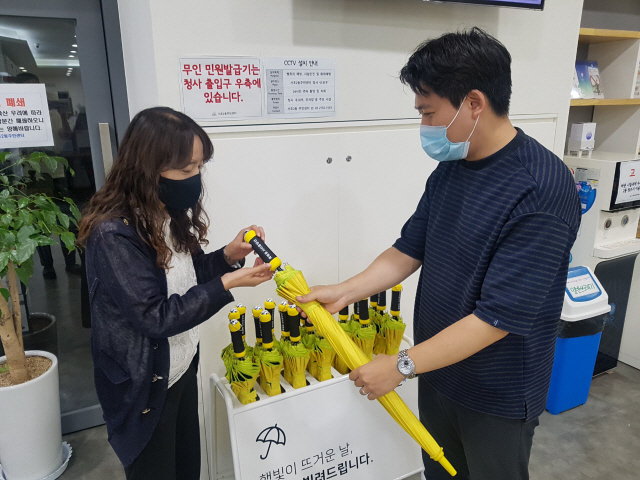 서초구민이 동주민센터에서 ‘서리풀양산’을 빌리고 있다./사진제공=서초구