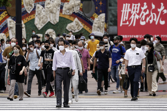 일본 도쿄에서 코로나19 하루 신규 확진자가 처음으로 400명을 넘어선 지난달 31일 시민들이 마스크를 착용한 채 번화가인 시부야의 횡단보도를 건너고 있다. /AP연합뉴스