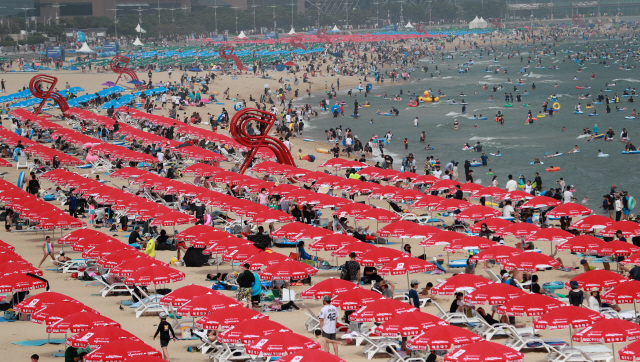 지난 2일 오후 부산 해운대해수욕장에서 피서객들이 더위를 식히고 있다. /연합뉴스