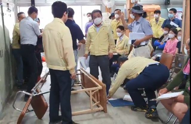 지난 16일 전남 구례시 구례군 오일장 상인회사무실에서 수해 현장을 찾은 조명래 장관에게 일부 주민이 탁자를 넘어뜨리며 항의하고 있다. /연합뉴스