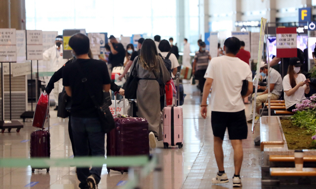 인천국제공항 입국자들이 지역별 격리를 위한 절차를 밟고 있다./연합뉴스