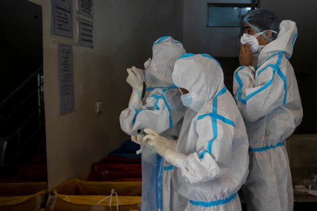 인도 수도 뉴델리의 한 병원에서 의료진들이 코로나19 치료를 위해 방역복을 입고 있다./로이터연합뉴스