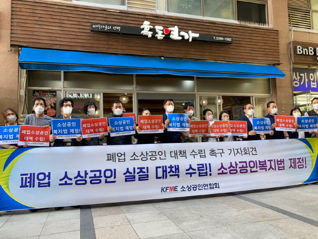 소상공연연합회가 18일 서울 신대방동 소재 한 식당 앞에서 폐업 소상공인 지원 대책을 촉구하는 기자회견을 열고 팻말을 들어보이고 있다./사진제공=소공연