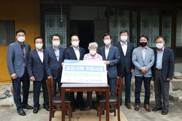 경남농협 윤해진(오른쪽에서 네번째) 본부장이 23일 의령군에서 관계자들과 효도식탁을 전달하고 있다./사진제공=경남농협