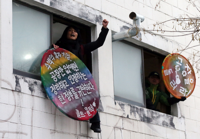 지난 2013년 2월5일 인천 부평구 콜트악기공장에서 공장점거 농성자들이 피켓을 들고 공장 폐쇄에 항의하고 있다. /인천=연합뉴스