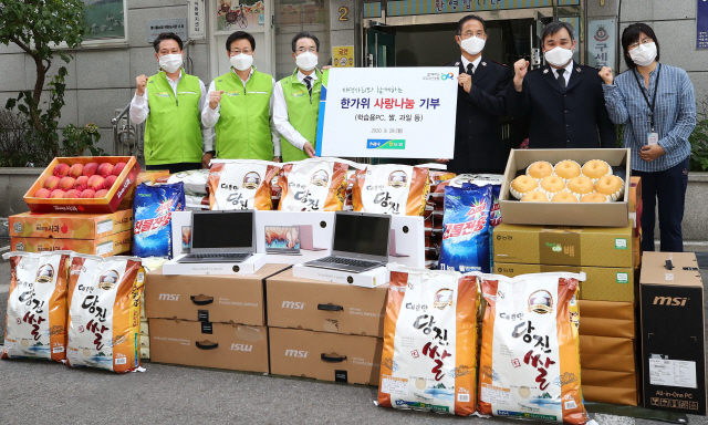 농협중앙회 임직원들이 28일 서울 서대문구 구세군서울후생원에서 원격교육을 위한 PC와 식·생활용품을 기부한 뒤 기념촬영을 하고 있다. /연합뉴스