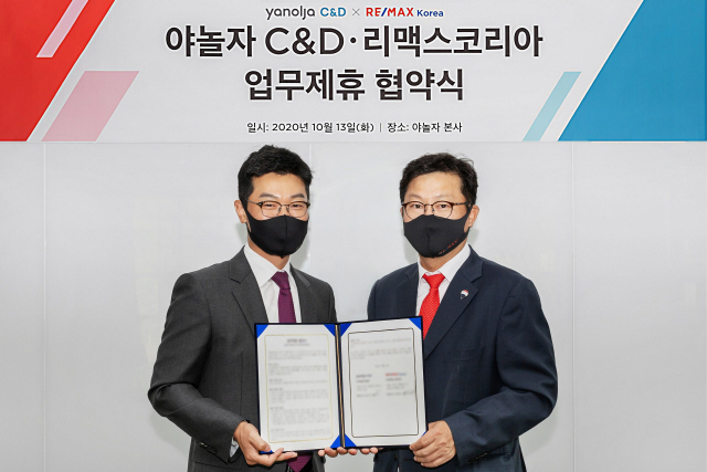 임상규(왼쪽) 야놀자 C&D 대표이사와 신희성 리맥스코리아 대표는 14일 강남구 야놀자 사옥에서 전략적 업무협약을 체결하고 협약서를 들어보이고 있다. /사진제공=야놀자