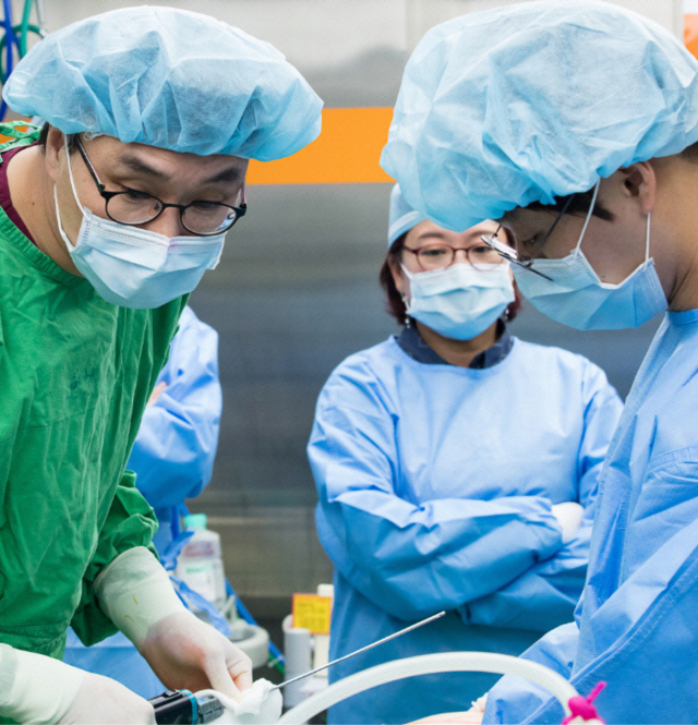 이선호(왼쪽) 대전 글로벌365mc병원 대표병원장이 외부 의료진이 지켜보는 가운데 피하지방을 캐뉼러로 빨아내는 지방흡입 수술을 하고 있다. /사진제공=365mc