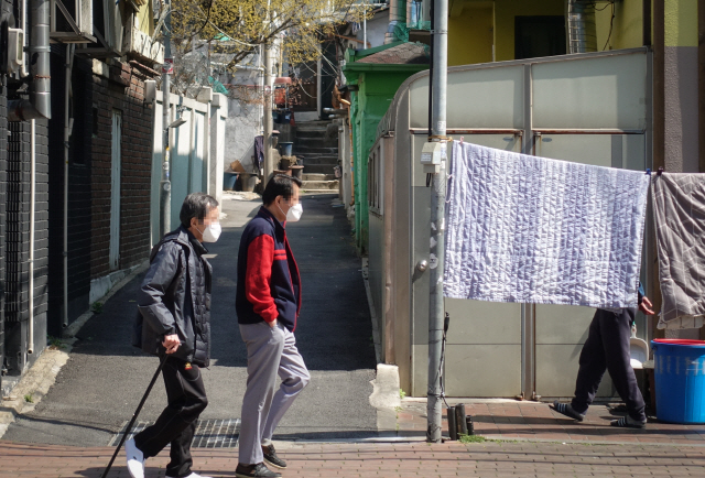 지난 3월 서울 용산구 동자동의 쪽방촌에서 노인들이 걸어가고 있다. /연합뉴스