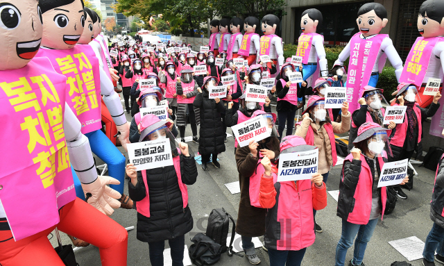 초등학교 돌봄전담사 등이 속한 학교비정규직연대회의가 하루 동안 총파업에 돌입한 6일 오전 돌봄전담사들이 서울 영등포구 여의도 더불어민주당 중앙당사 앞에서 돌봄교실 민영화 반대 및 8시간 전일제 전환을 촉구하는 구호를 외치고 있다./오승현기자 2020.11.06