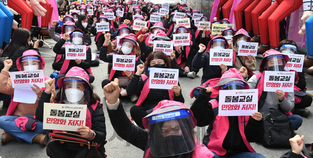 초등학교 돌봄전담사 등이 속한 학교비정규직연대회의가 하루 동안 총파업에 돌입한 6일 오전 돌봄전담사들이 서울 영등포구 여의도 더불어민주당 중앙당사 앞에서 돌봄교실 민영화 반대 및 8시간 전일제 전환을 촉구하는 구호를 외치고 있다./오승현기자 2020.11.06