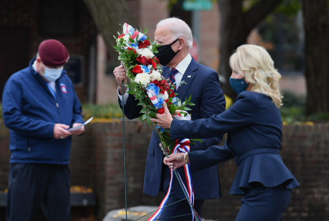 조 바이든 미국 대통령 당선인(왼쪽)이 11일(현지시간) 재향군인의 날을 맞아 부인 질 바이든 여사와 함께 필라델피아의 한국전 기념비를 찾아 헌화하고 있다. /AFP연합뉴스
