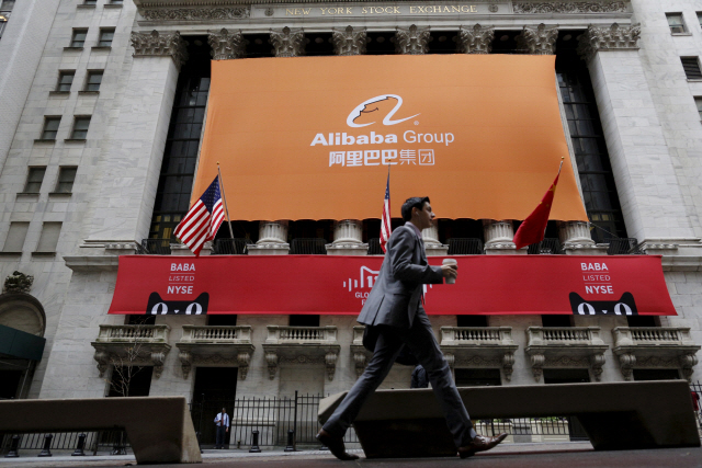 FILE PHOTO: Signage for Alibaba Group Holding Ltd. covers the front facade of the New York Stock Exchange November 11, 2015.    REUTERS/Brendan McDermid/File Photo