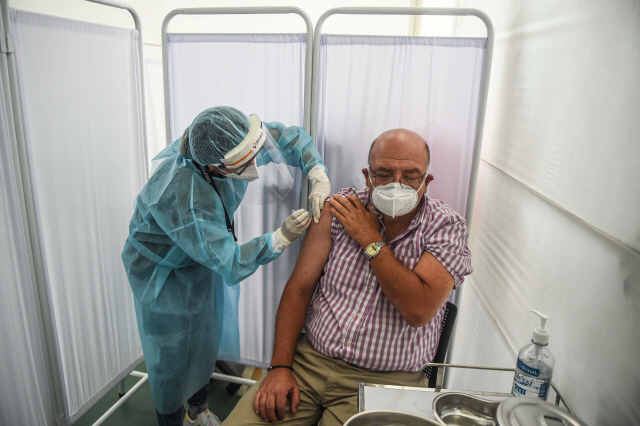 페루 수도 리마의 카예타노 에레디아 대학 임상연구센터에서 9일(현지시간) 한 의료인이 임상시험 자원자의 팔에 중국 시노팜이 생산한 신종코로나바이러스감염증(코로나19) 백신을 접종하고 있다./연합뉴스