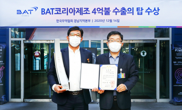 14일 경남 사천에 있는 BAT코리아 사천공장에서 강승호(왼쪽) BAT 코리아 상무가 최주철 한국무역협회 경남지역본부장으로부터 대통령표창을 수여받고 함께 사진촬영을 하고 있다./사진제공=BAT코리아