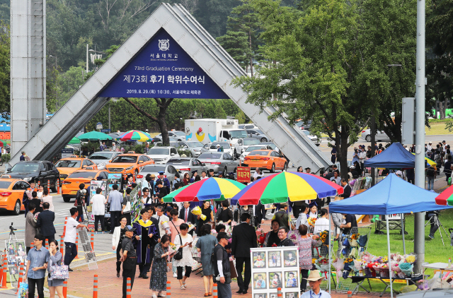 서울 관악구 서울대학교에서 지난해 8월 열린 후기 학위수여식에 참석하는 졸업생과 가족들이 정문 앞을 지나고 있다. /연합뉴스