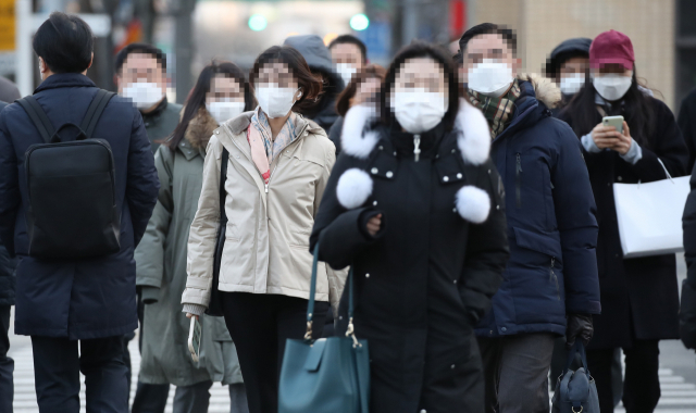 서울 세종로사거리에서 마스크를 쓴 시민들이 횡단보도를 건너고 있다./연합뉴스