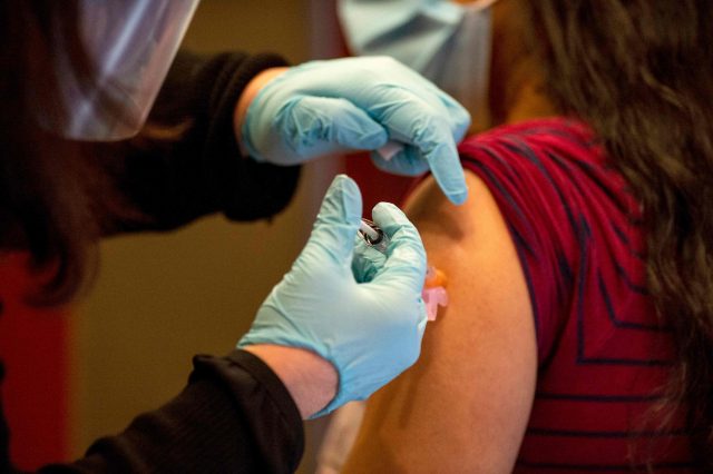 미국 코네티컷주 하트퍼드 병원에서 한 의사가 모더나의 신종 코로나바이러스 감염증(코로나19) 백신을 접종받고 있다. 미국에서 인종에 따라 신종 코로나바이러스 감염증(코로나19) 백신 접종률이 차이 난다는 의심이 사실인 것으로 통계에서 드러났다./AFP연합뉴스