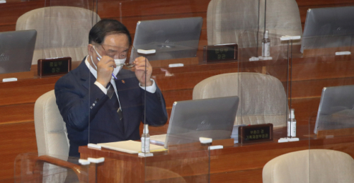 홍남기 경제부총리가 5일 국회 본회의에서 진행된 경제분야 대정부질문에서 안경을 고쳐 쓰고 있다. /연합뉴스