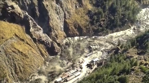 This frame grab from video provided by KK Productions shows a massive flood of water, mud and debris flowing at Chamoli District after a portion of Nanda Devi glacier broke off in Tapovan area of the northern state of Uttarakhand, India, Sunday, Feb.7, 2021. (KK Productions via AP) THIS CONTENT IS INTENDED FOR EDITORIAL USE ONLY. FOR OTHER USES, ADDITIONAL CLEARANCES MAY BE REQUIRED. IMAGE FROM VIDEO