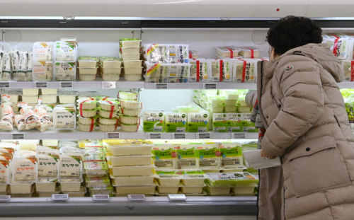 유가에 이어 대두, 옥수수 등 곡물가격이 급등세를 보이며 국내 가공식품 가격이 들썩이고 있다. 16일 서울 시내 한 마트에서 장을 보는 시민이 전주보다 10%나 가격이 오른 두부를 고르며 망설이고 있다. /성형주기자
