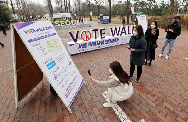 21일 오전 서울 광진구 어린이대공원 후문 입구에 설치된 서울시장 보궐선거 투표를 독려하는 조형물 앞에서 시민들이 사진을 찍고 있다./연합뉴스