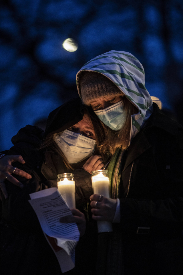 BOULDER, CO - MARCH 25: Mourners attend a vigil to commemorate the victims at the King Soopers grocery store shooting March 25, 2021 in Boulder, Colorado. The Monday shooting left ten people dead, including one police officer Chet Strange/Getty Images/AFP == FOR NEWSPAPERS, INTERNET, TELCOS & TELEVISION USE ONLY ==