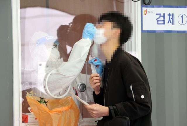 지난 30일 서울역 광장에 마련된 신종 코로나바이러스 감염증(코로나19) 임시 선별검사소에서 의료진이 검체를 채취하고 있다./연합뉴스