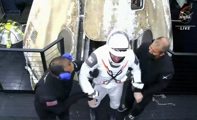 미국 민간 우주탐사 기업 스페이스X의 유인 캡슐 ‘크루드래건’을 타고 국제우주정거장(ISS)을 출발해 2일(현지 시간) 지구에 귀환한 우주비행사(가운데)가 스태프들의 도움을 받아 캡슐을 빠져나오고 있다. 크루드래건은 4명의 우주비행사를 태우고 이날 미국 플로리다주 팬핸들 인근 멕시코만에 야간 착수(着水)했다. 미 항공우주국(NASA) TV 화면 캡처. /AFP연합뉴스