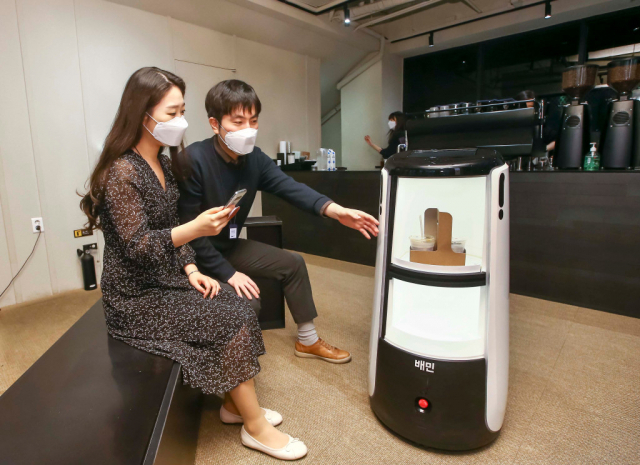 서울 종로구 D타워 광화문에서 우아한형제들의 배달로봇 '딜리타워'가 커피 배달 서비스를 시연하고 있다./사진 제고=우아한형제들