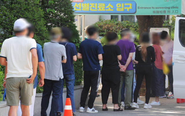 지난 12일 오전 서울 강동구 보건소 선별진료소에서 시민들이 코로나19 검사를 받기 위해 대기하고 있다./연합뉴스