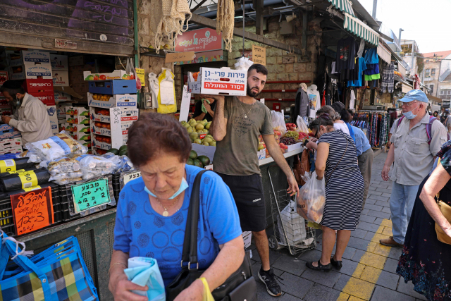이스라엘 예루살렘의 주민들이 지난 1일 시장에서 생필품을 구입하고 있다. 이스라엘은 이날부터 실내 마스크 착용과 출입국 제한 이외의 모든 코로나19 방역 조치를 해제했다./AFP연합뉴스