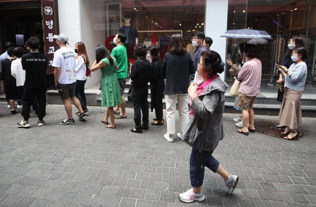 지난 21일 서울 명동의 한 음식점 앞에 시민들이 좁은 간격을 두고 입장을 기다리고 있다./연합뉴스