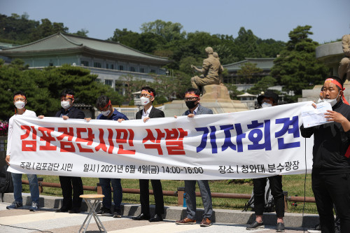 김포·인천 검단지역 시민단체 회원들이 지난 4일 오후 서울 청와대 분수대 앞에서 열린 삭발 기자회견에서 광역급행철도(GTX) D 노선의 강남 직결과 서울지하철 5호선 김포 연장 등을 촉구하고 있다. /연합뉴스