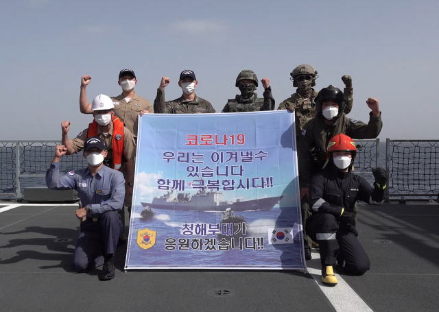 청해부대원들이 해외 파병중이던 올해 설 명절 함정 위에서 코로나19 극복을 응원하는 플래카드를 들고 있는 모습. /연합뉴스