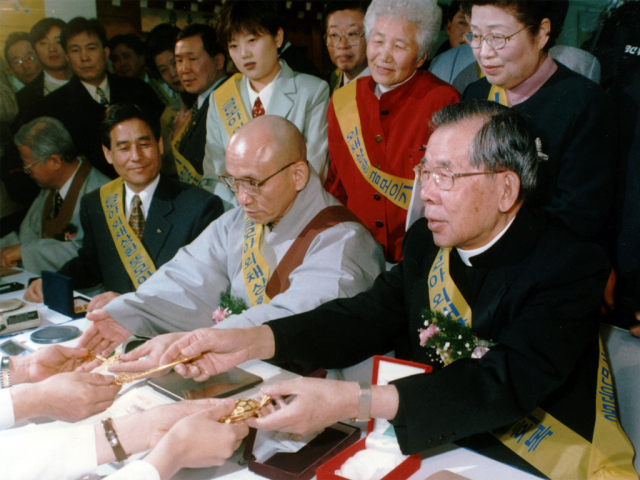 지난 1997년 금모으기 운동에 참여한 월주스님(사진 왼쪽)과 고(故) 김수환 추기경./사진제공=조계종