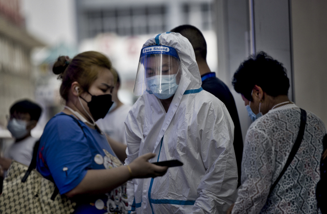 29일 중국 상하이 지하철에서 방역 요원들이 승객의 휴대폰 건강 코드를 확인하고 있다. /EPA연합뉴스